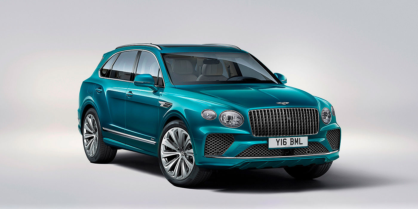 Bentley Cambridge Bentley Bentayga Azure front three-quarter view, featuring a fluted chrome grille with a matrix lower grille and chrome accents in Topaz blue paint.